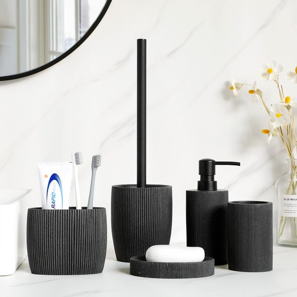 Black bathroom accessory set including soap dispenser, toothbrush holder, tumbler, dish, mouthwash cup, and toilet brush