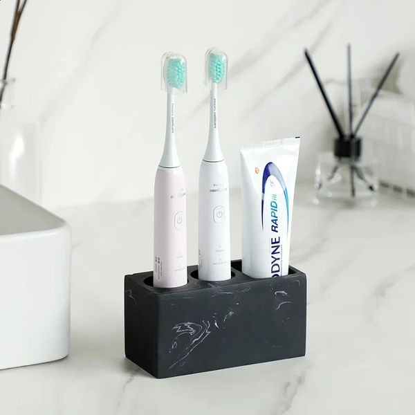 Black electric toothbrush holder for bathroom organization, storing brushes and toothpaste in white