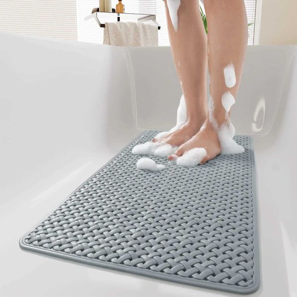 Non-slip shower mat with suction cups and drainage holes, soft and machine-washable, ideal for kids