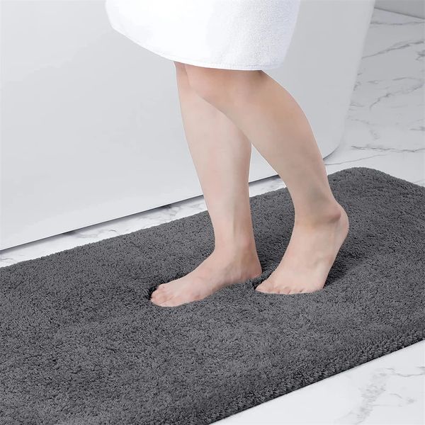 Soft shaggy bathroom rug with thick plush texture, machine washable and non-slip, measuring 24x16 inches