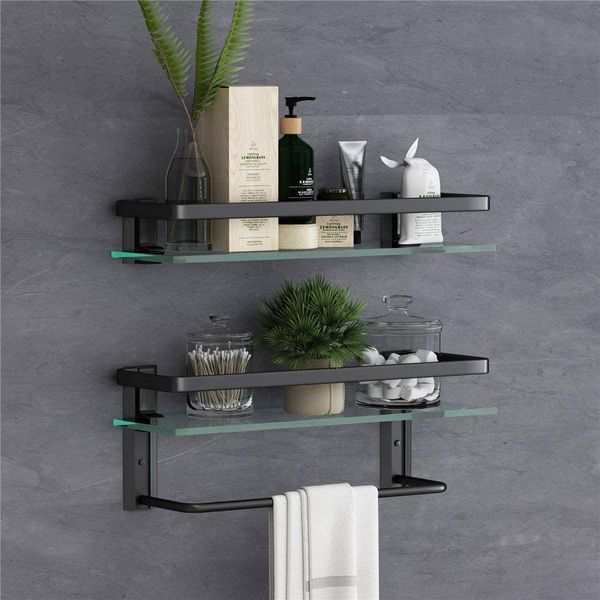 Wall-mounted 15.7" two-tier floating glass shelf featuring an integrated towel rack, clear design for bathroom use