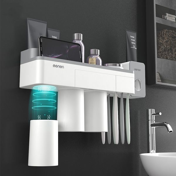 Wall-mounted bathroom organizer with toothbrush holder, toothpaste dispenser, and automatic squeezer for efficient storage